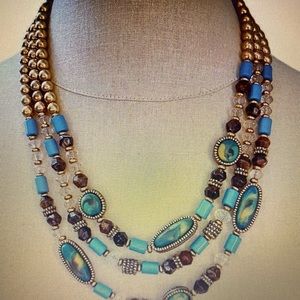 Chico’s Statement Necklace, three strands of gold tone,blue and green beads.